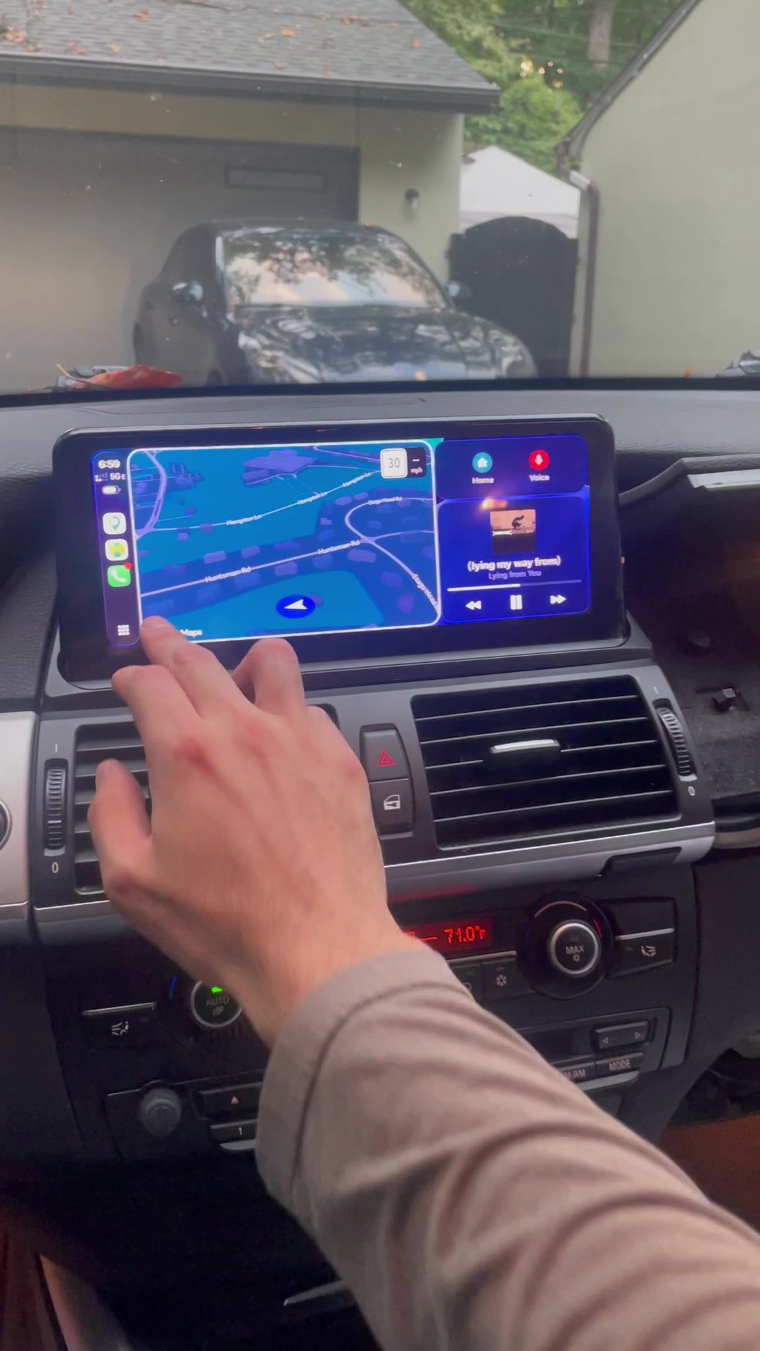The same X5 after installation, with CarPlay on the larger touchscreen