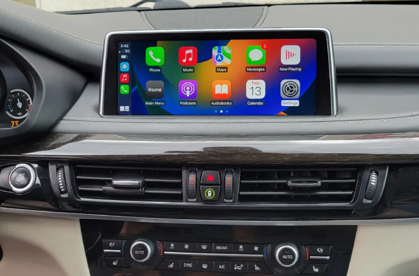 Real BMW dashboard showing Apple CarPlay on its screen