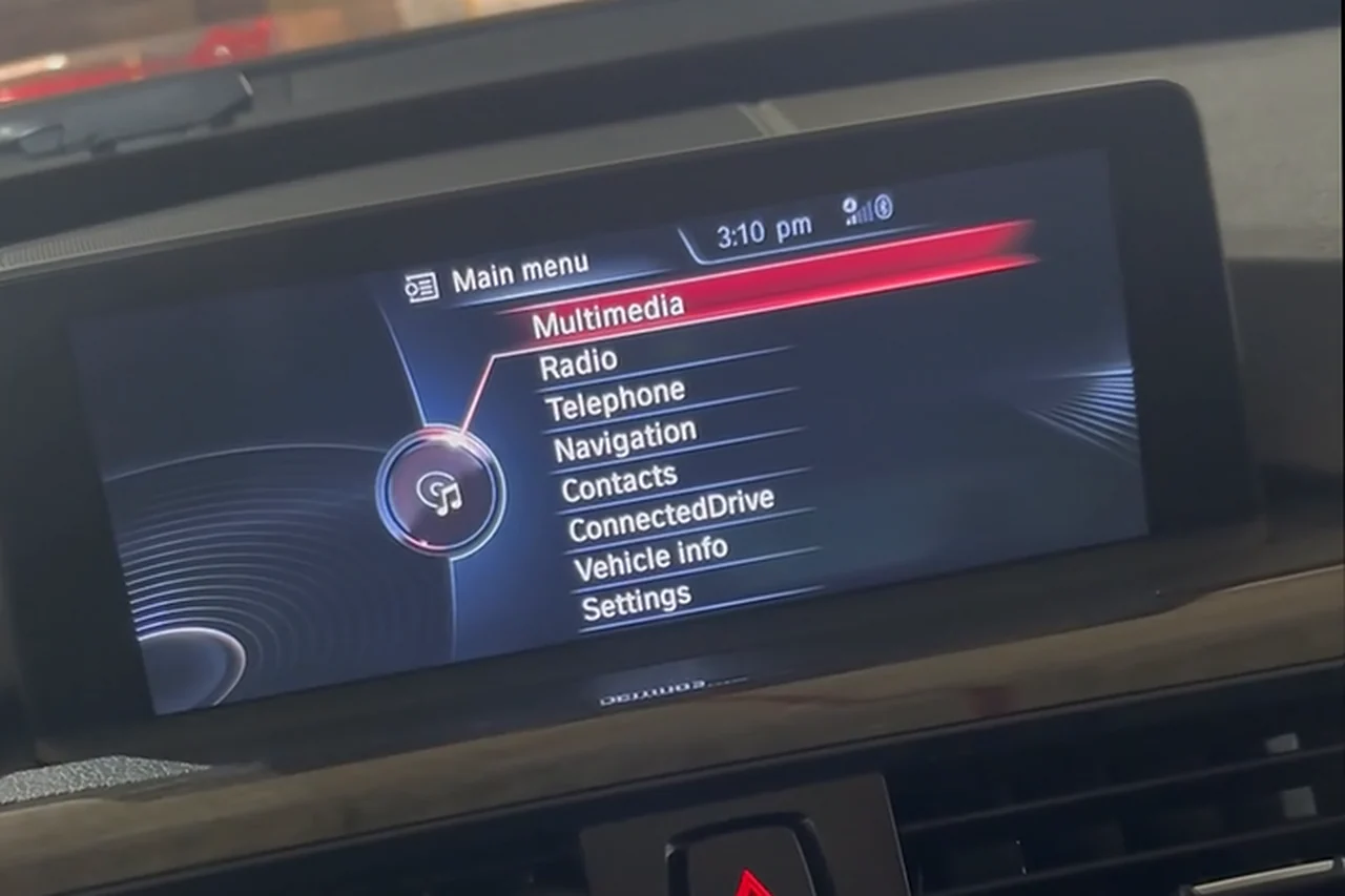 The original BMW display in the 2015 BMW 328i GT, showing the factory iDrive main menu