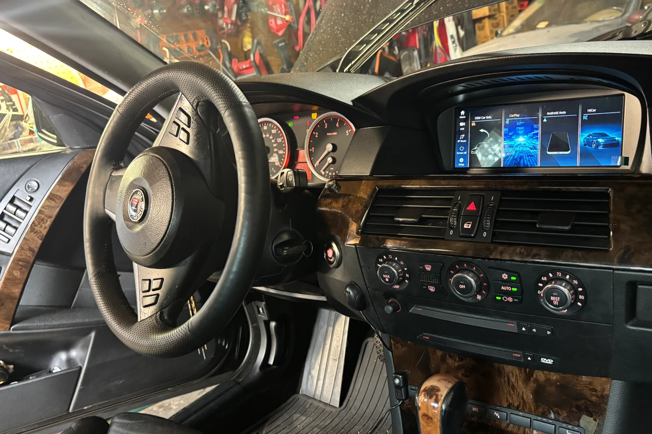 The same 2007 BMW 550i after installation, with the new widescreen touchscreen in the original screen hood